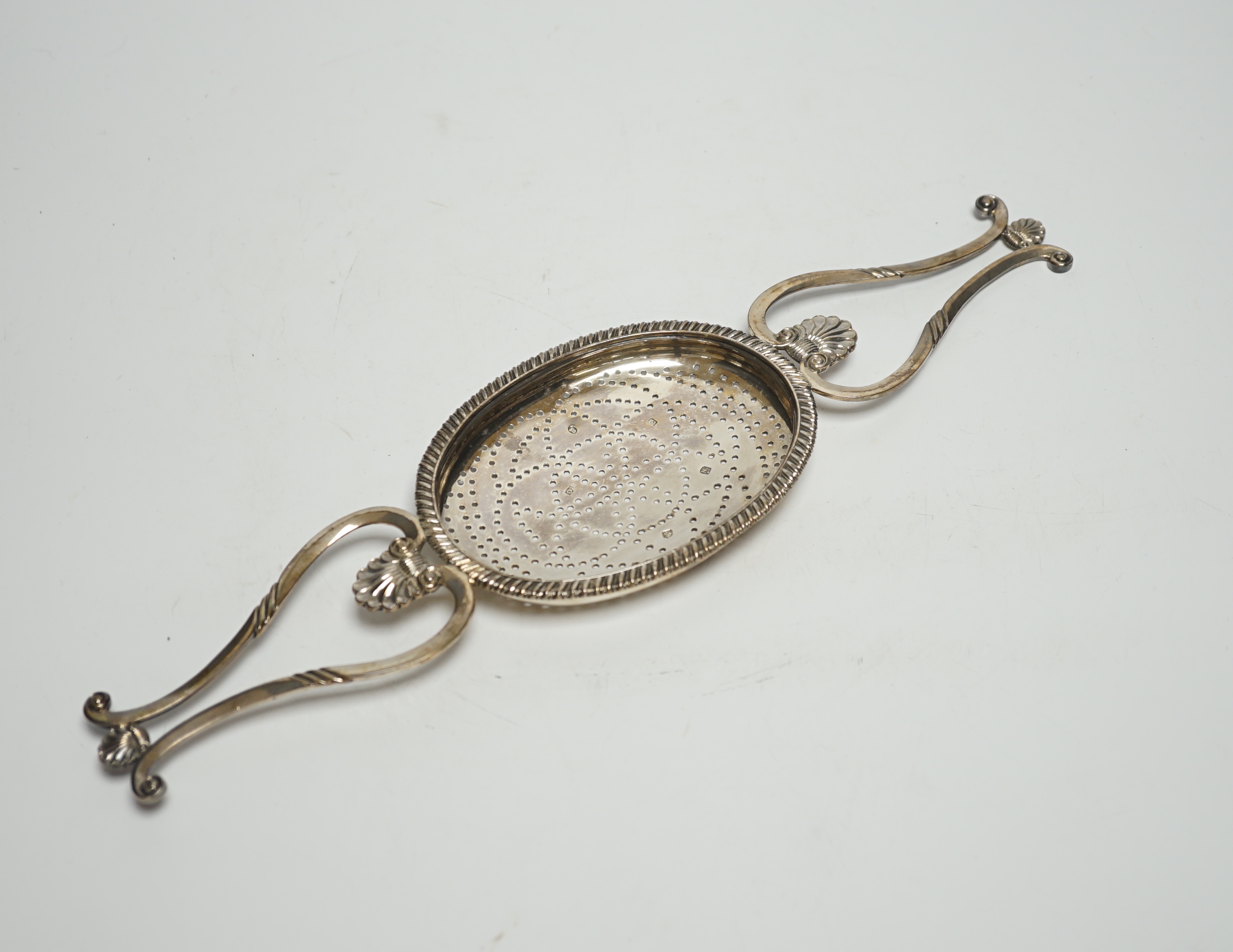 A George IV Scottish silver lemon strainer, Philip Grierson, Glasgow, 1821, 33.3cm, 167 grams